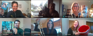 members from financial aid hold up items that remind them of seafood while over a video call